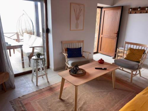a living room with a coffee table and chairs at Urla Sunrise House in Ildır