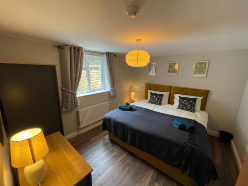 a bedroom with a large bed and a table at Flat 2, 297 Gillott Road, B16 0RT in Birmingham