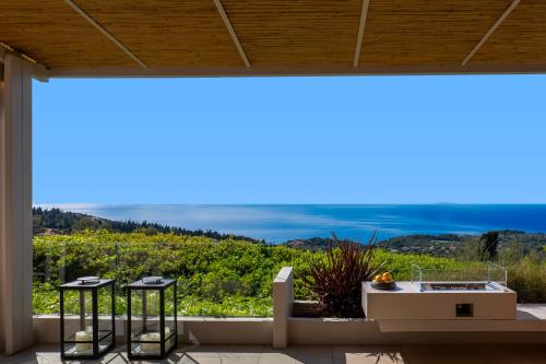 a view from the balcony of a house with a tub at Artblue Villas in Tsoukaladhes