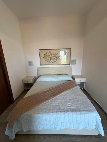 a bedroom with a bed and two night stands at B&B Agriturismo Grandola in Montecalvo Irpino