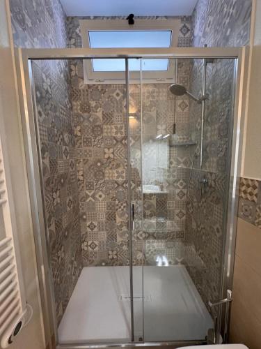 a shower with a glass door in a bathroom at House Pale Rooms in Palau