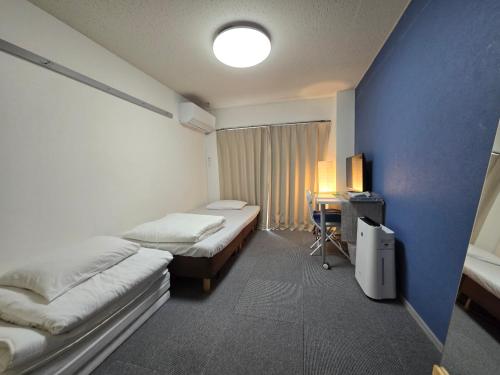 Ένα ή περισσότερα κρεβάτια σε δωμάτιο στο エバグリーンヴィラ太秦203さくら