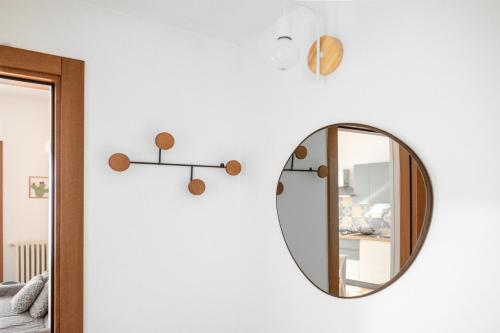 a mirror hanging on a white wall in a living room at Corte Curatolo in Martano