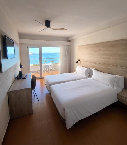 a hotel room with two beds and a view of the ocean at Mirador del Cabo Designed For Adults in Aguadulce