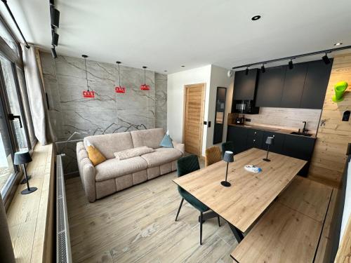 un salon avec un canapé et une table dans l'établissement Appartement T3 - Emplacement exceptionnel - entrée indépendante - entièrement rénové, à Tignes