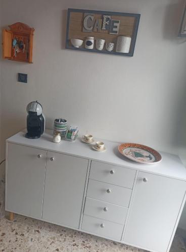 a white cabinet with a plate on top of it at Casa Agrumeto in Nunziata in Nunziata
