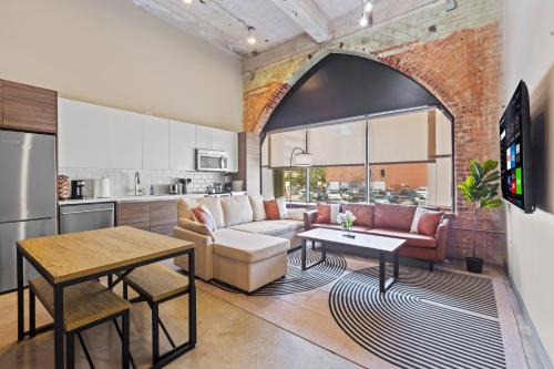 an open kitchen and living room with a brick wall at Luxury - Kay Bailey - Free Parking in Dallas