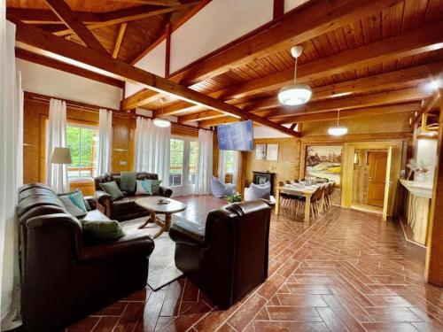 a living room with couches and a dining room at Haus Palazzo in Bosanska Krupa