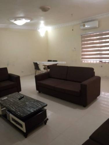 a living room with a couch and a table at Sunset Homes in Trofwi