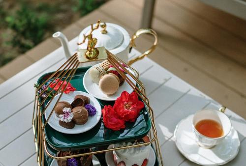 a tray of pastries and tea on a table at Timber Society Boutique Hideaway in Phuket Town