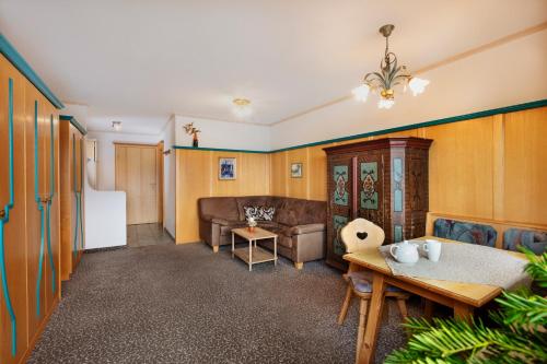 a living room with a couch and a table at Appartementanlage Kerber in Seefeld in Tirol
