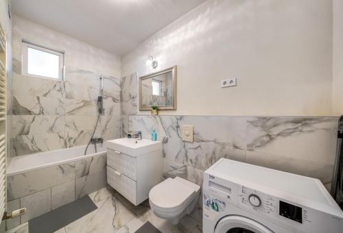 Un baño con lavabo, inodoro y bañera. en Akácfa 413 City Getaway, en Budapest