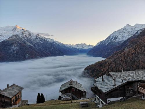 a view of a foggy valley with snowy mountains at Ferienwohnung Morgengruss in Sankt Niklaus
