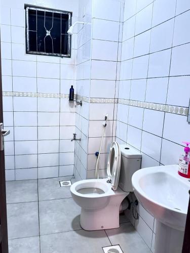 a bathroom with a toilet and a sink at Mima homes in Gatunga