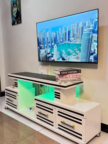 a tv sitting on top of a white entertainment center at Mima homes in Gatunga