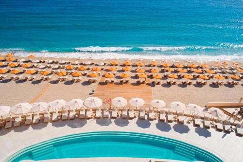 an aerial view of a beach with umbrellas and the ocean at Konstantinos Palace in Karpathos