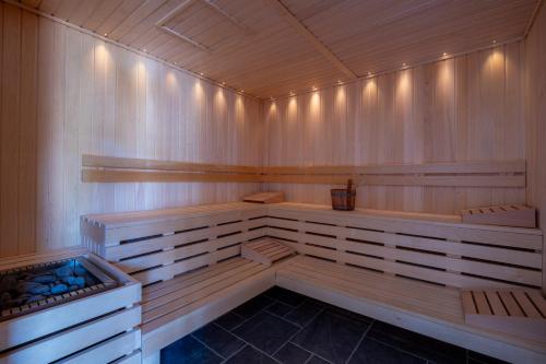 a sauna with wooden benches and aificialificialificialificialificialificialificialificial at Hôtel de la Plage in Plonévez-Porzay