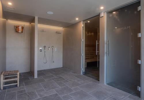 a bathroom with a shower and a walk in shower stall at Hôtel de la Plage in Plonévez-Porzay