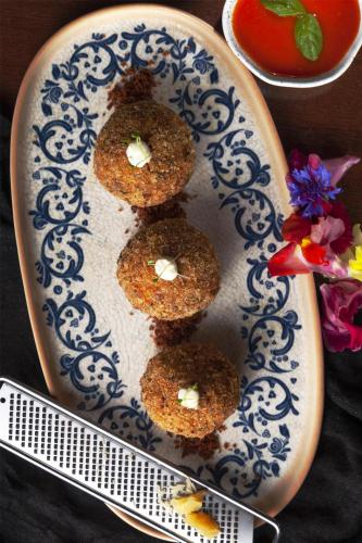 a plate with four muffins with butter on it at NH Collection Bogota Andino Royal in Bogotá