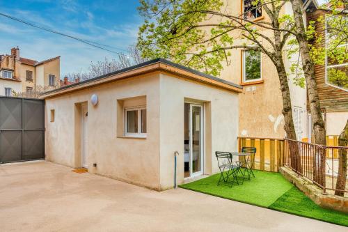 Cette maison dispose d'une terrasse avec une table et des chaises. dans l'établissement Le Petit Atelier - Climatisé extérieur - Jean Macé, à Lyon