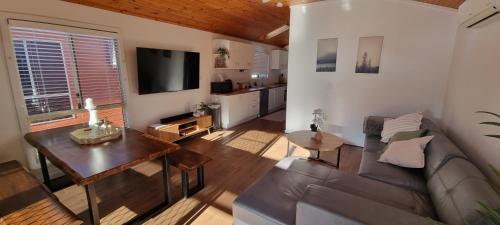 a living room with a couch and a table at The Riverstay Retreat in Wisemans Ferry