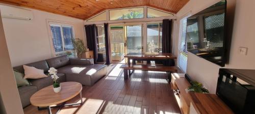 a living room with a couch and a table at The Riverstay Retreat in Wisemans Ferry