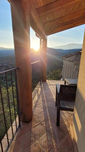 a porch with a bench on a balcony with the sunset at Luciae Domus in Roccascalegna