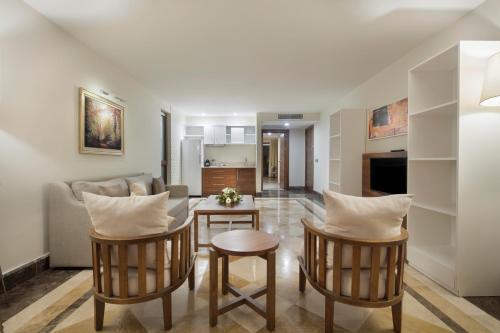 a living room with a couch and a table and chairs at Nirvana Mediterranean Excellence - Ultra All Inclusive in Beldibi