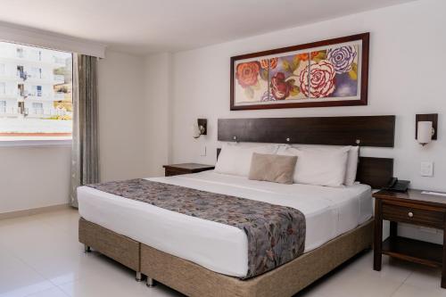 Una cama o camas en una habitación de Hotel Arhuaco Rodadero
