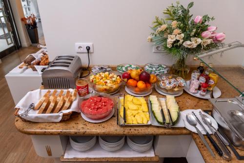 a table with a bunch of food on it at Hotel Marina Rio in Lagos