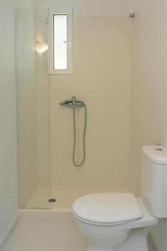 a white bathroom with a shower and a toilet at Serenity Suite in Corfu - Escape to Paradise in Kouspádes
