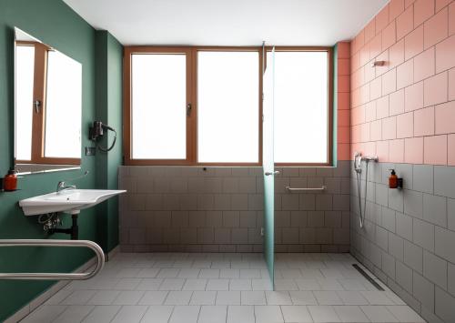 a bathroom with a shower and a sink at Zeus is Loose Hostel in Thessaloniki