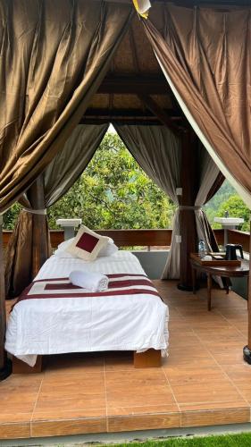 a bedroom with a bed in a tent at Mandhasativa Homestay in Singaraja