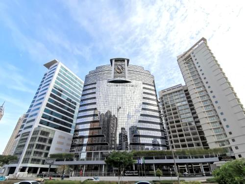 a tall building with a clock on top of it at Signature 1 Hotel Tecom in Dubai