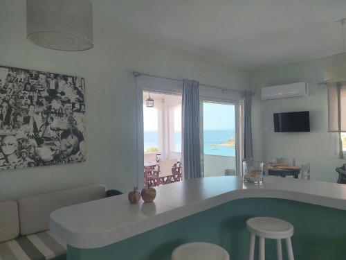 a kitchen and living room with a view of the ocean at Kini Bay in Kinion