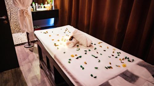 a hospital bed with flowers and a stuffed animal on it at Signature 1 Hotel Tecom in Dubai