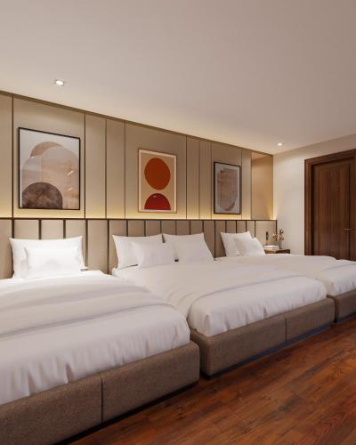 a row of three beds in a room at Splendid Secret Hotel in Hanoi