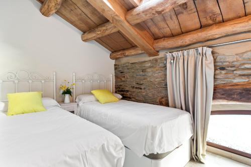 - 2 lits blancs dans une chambre avec fenêtre dans l'établissement Ático Casa Venancio, à Trabada