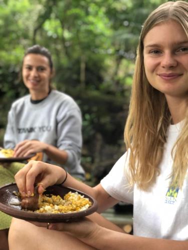 a woman holding a plate of food with a man at Genderless Jungle in Matale