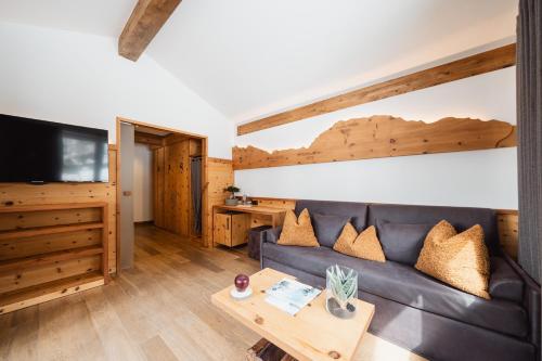 a living room with a couch and a table at Montresor Hotel Pfeldererhof in Pfelders
