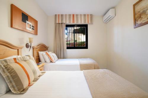 Ένα ή περισσότερα κρεβάτια σε δωμάτιο στο Macdonald Doña Lola Resort