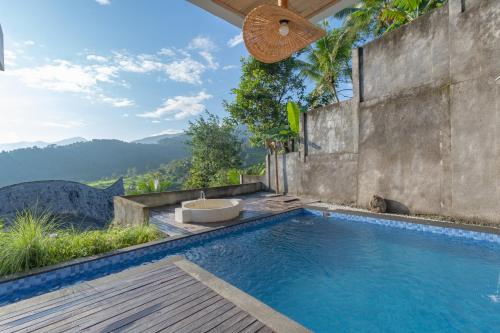 a swimming pool with a view of the mountains at Maha Hills Resort by Mahaprana Experience in Lovina