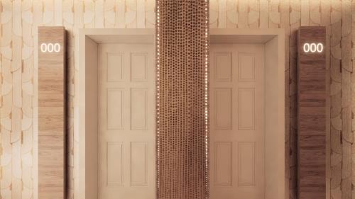 two doors with numbers on them on a wall at Hotel Al Mandar in Dakhla