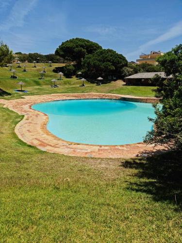 a large pool of water in a field at Albur Beach House in Alvor