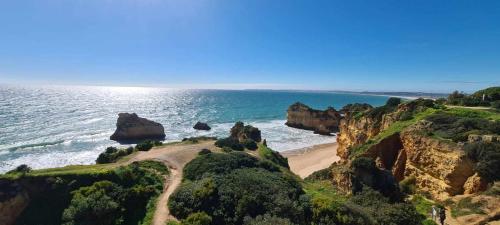a view of a beach with rocks in the ocean at Albur Beach House in Alvor