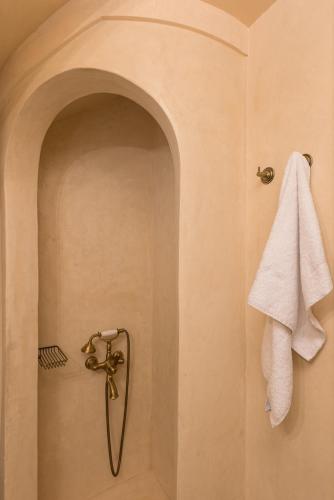 a shower with a white towel hanging on a wall at panacea zagori in Tsepelovo