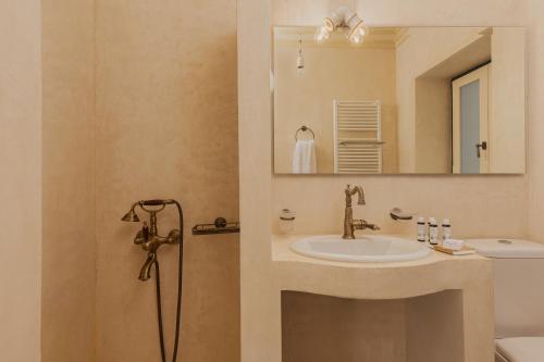 a bathroom with a sink and a mirror at panacea zagori in Tsepelovo