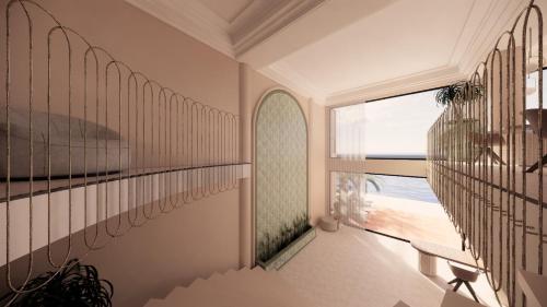 a room with a balcony with a view of the ocean at Hotel Al Mandar in Dakhla