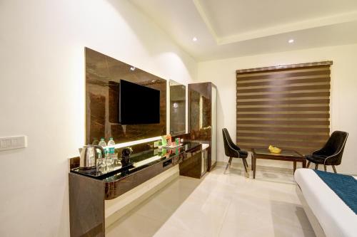 a hotel room with a bed and a television at Hotel Krishna - By RCG Hotels, Centrally Located, New Delhi in New Delhi