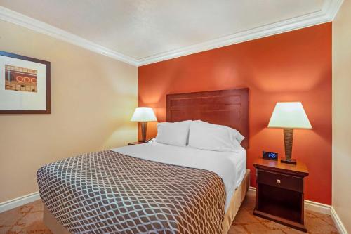 a hotel room with a bed and two lamps at Best Western PLUS Mirage Hotel and Resort in High Level